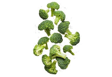 Brócoli crudo. Brócoli orgánico fresco y limpio para una alimentación saludable que vuela y rebota en el aire en un estudio sobre un fondo blanco para el bienestar.