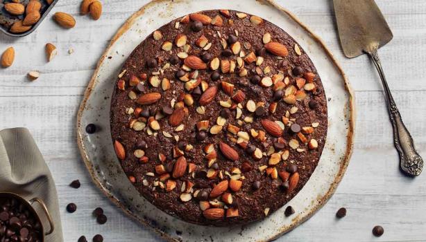 Torta de chocolate decorada con almendras sin pelar enteras y trituradas  