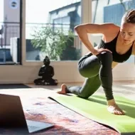 Mujer estirando en casa y haciendo ejercicios de cardio para principiantes