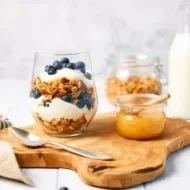Granola con yogurt griego y miel para alimentarse balanceadamente.